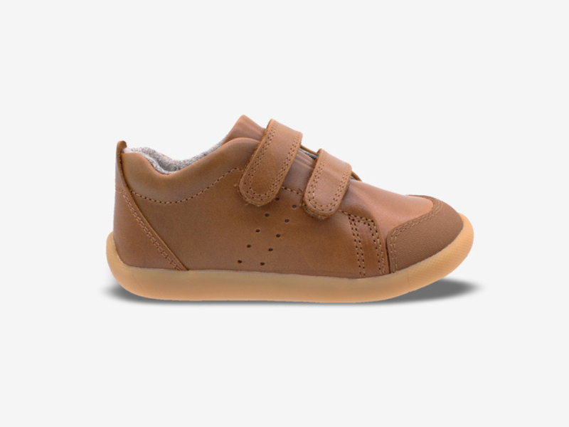 Brown children's shoe with velcro straps on a white background
